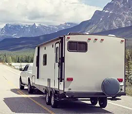 Our Services 4 Caravan or recreational vehicle motor home trailer on a mountain road in Canada